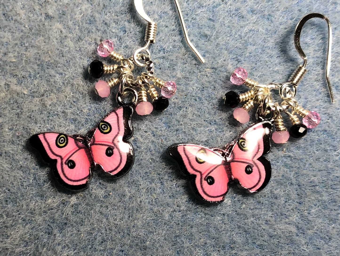 Pink and black enamel butterfly charm earrings adorned with tiny dangling pink and black Chinese crystal beads.