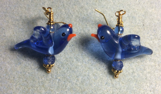 Blue lamp work flying bird bead earrings adorned with blue Czech glass beads.