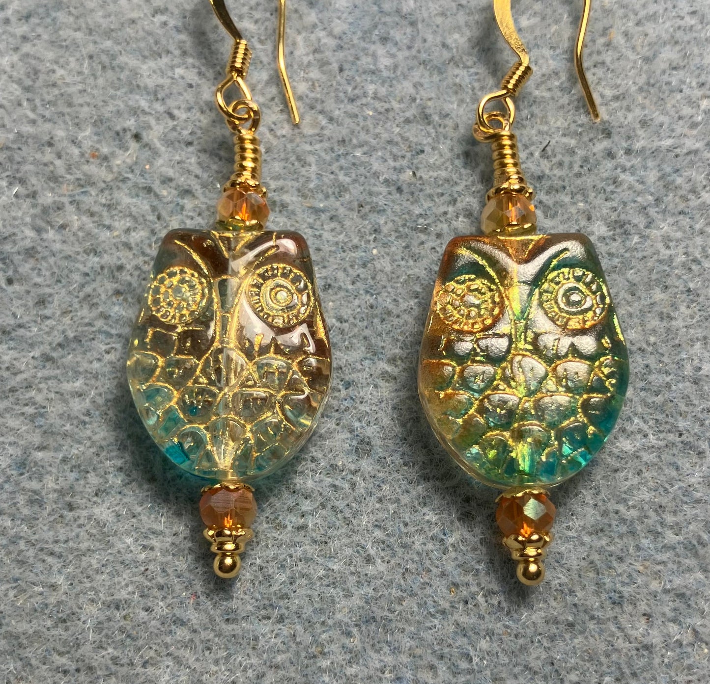 Sparkly green and orange (with gold wash) Czech glass owl bead earrings adorned with orange Chinese crystal beads.
