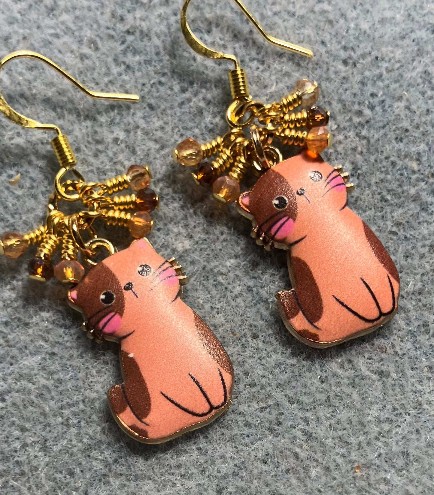 Orange and brown enamel cat charm earrings adorned with tiny dangling orange and brown Chinese crystal beads.