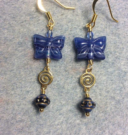 Bright blue Czech glass butterfly bead earrings adorned with gold swirly connectors and bright blue Czech glass Saturn beads.