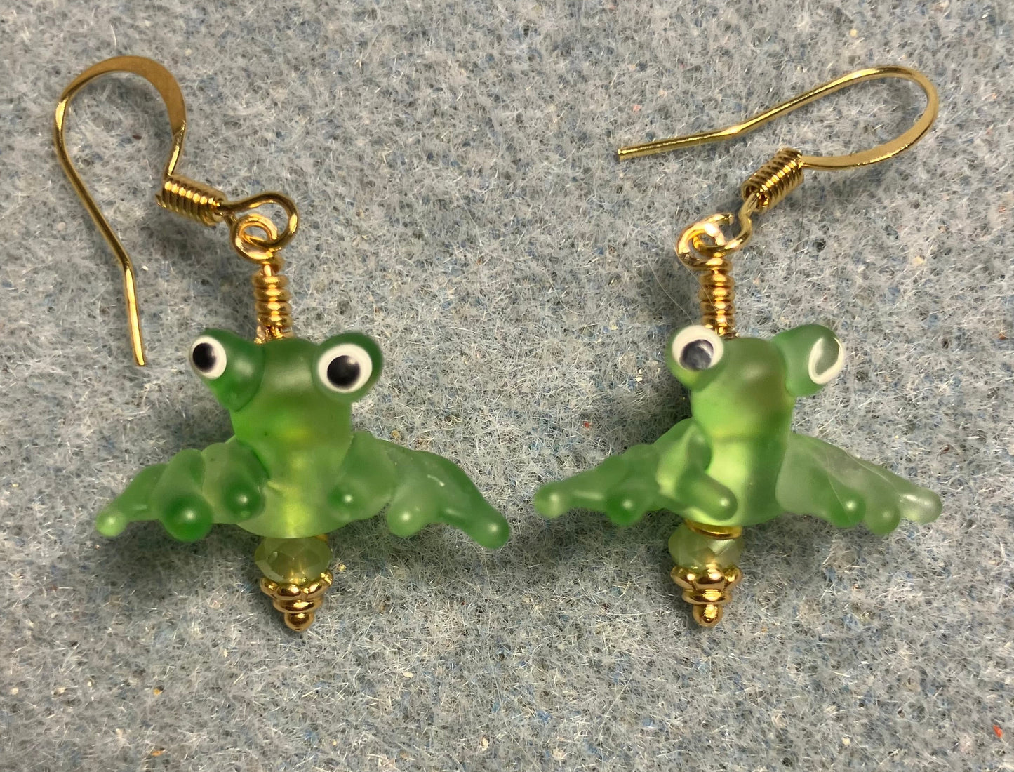 Tiny olive green lamp work frog bead earrings adorned with tiny olive green Chinese crystal beads.