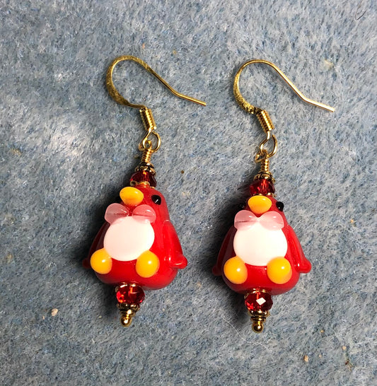 Red and white lamp work penguin bead earrings adorned with red Chinese crystal beads.