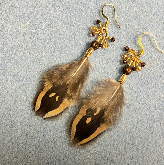 Brown and amber pheasant feather earrings adorned with brown Czech glass melon beads and small dangling brown and amber Czech glass beads.
