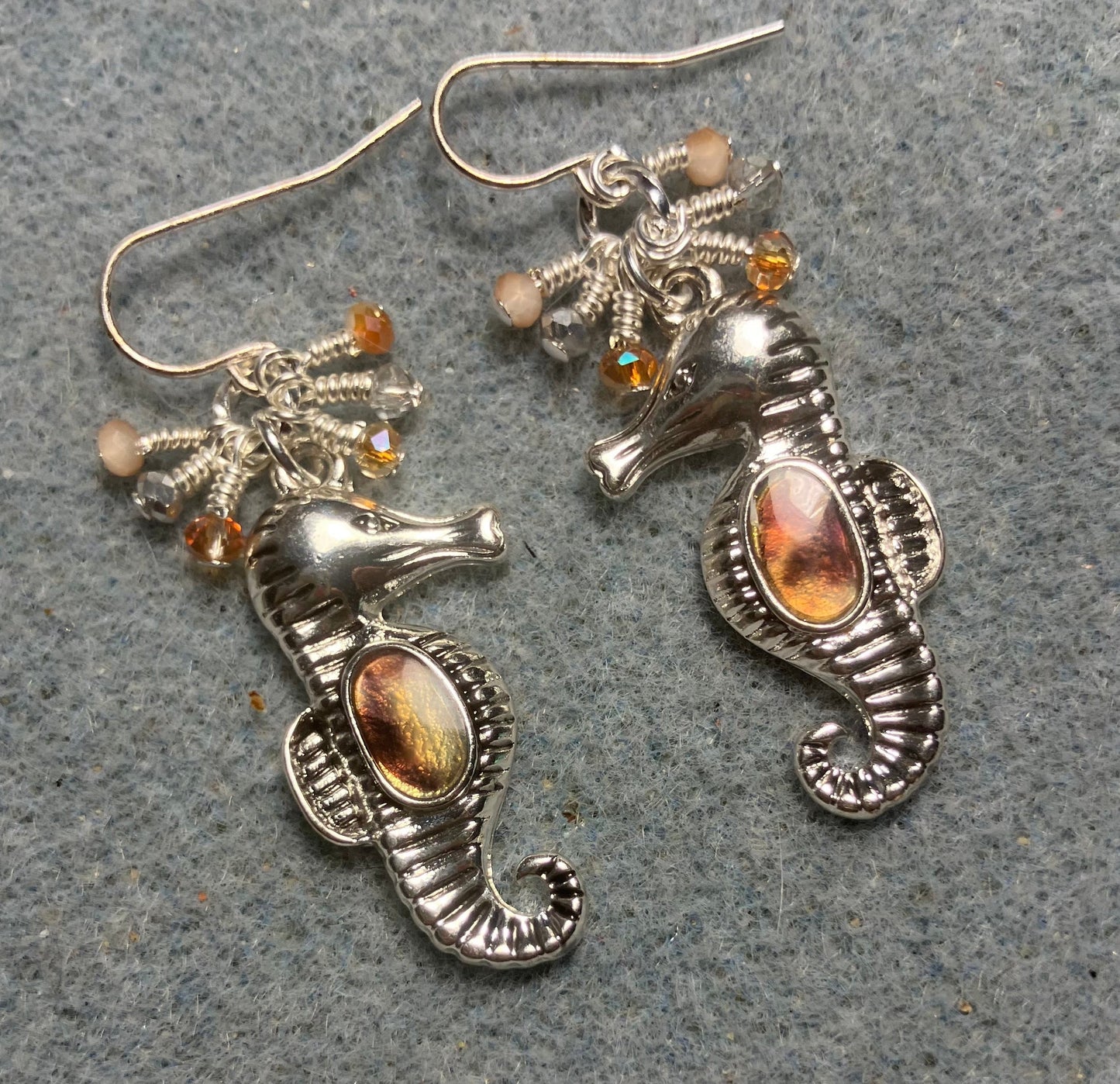 Silver and peach brown abalone seahorse charm earrings adorned with tiny dangling peach and silver Chinese crystal beads.