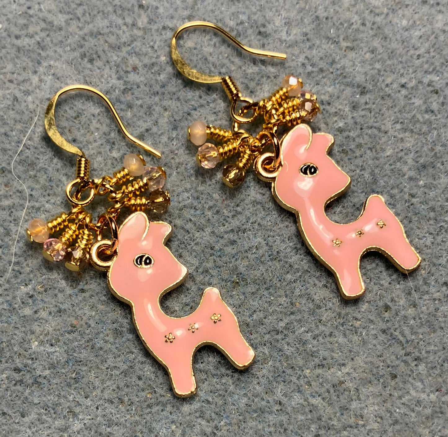 Peach pink enamel deer charm earrings adorned with tiny dangling pink and peach Chinese crystal beads.