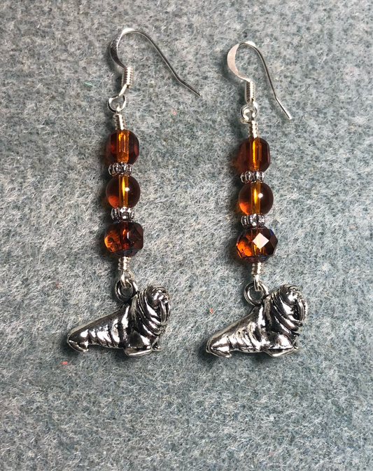 Silver walrus charm earrings adorned with topaz Czech glass beads.