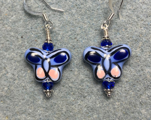 Blue and pink ceramic butterfly bead earrings adorned with dark blue Chinese crystal beads.