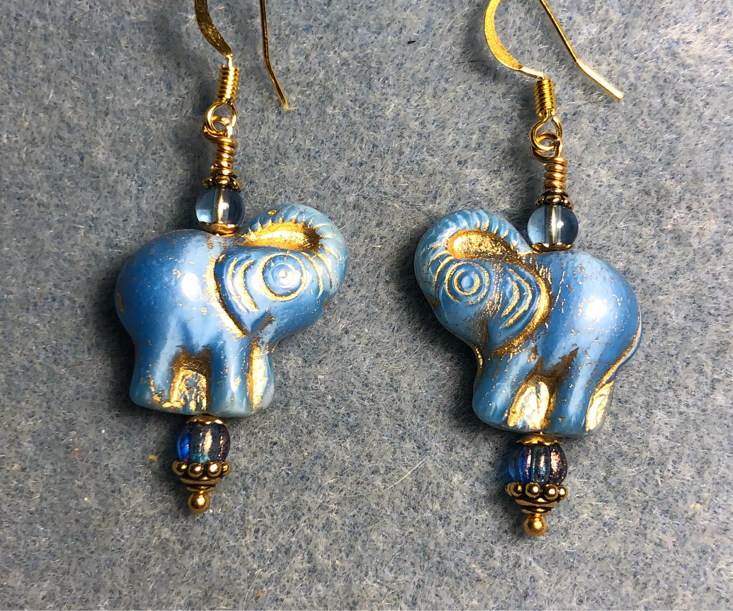 Opaque light blue (with gold inlay) Czech glass elephant bead earrings adorned with light blue Czech glass beads.