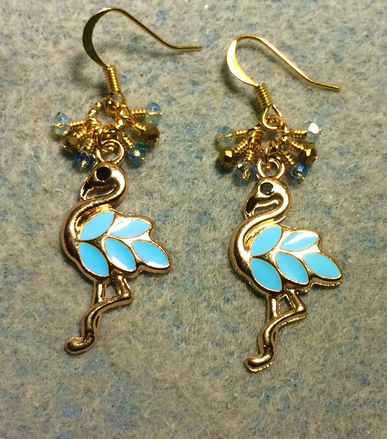 Light aqua and gold enamel flamingo charm earrings adorned with tiny dangling aqua and gold Chinese crystal beads.