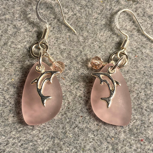 Small pink sea glass pendant bead earrings adorned with small silver dolphin charms and small pink Chinese crystal beads.