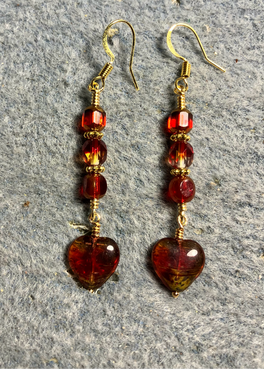 Small red (with a touch of yellow) Czech glass heart bead earrings adorned with red and red yellow Czech glass beads.