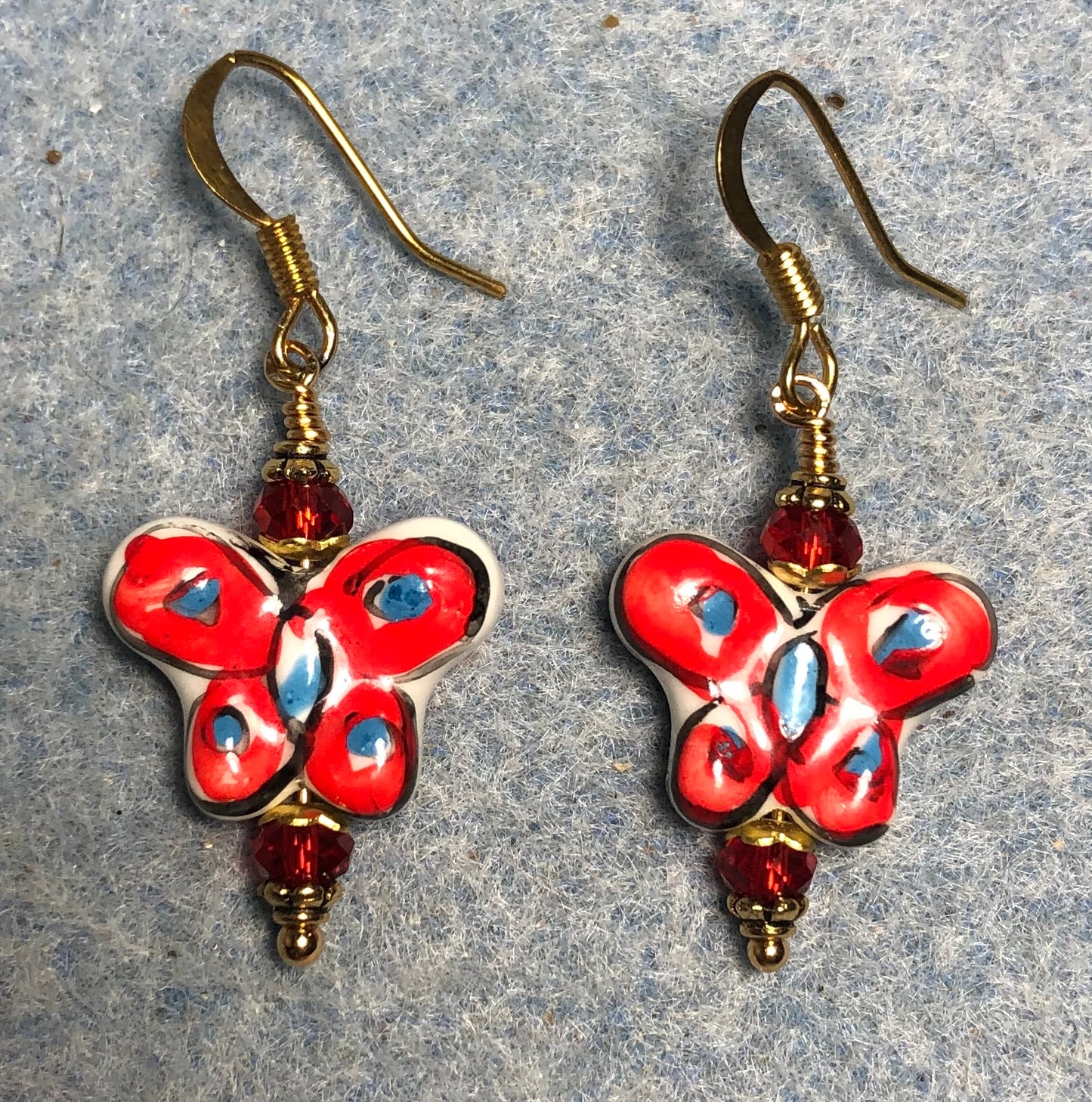 Red and blue ceramic butterfly bead earrings adorned with red Chinese crystal beads.