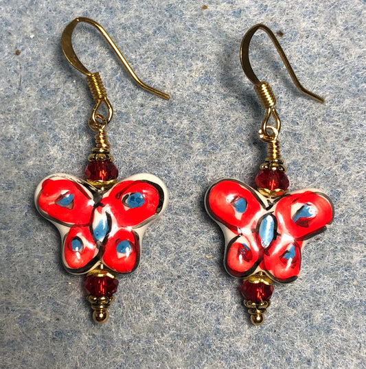 Red and blue ceramic butterfly bead earrings adorned with red Chinese crystal beads.