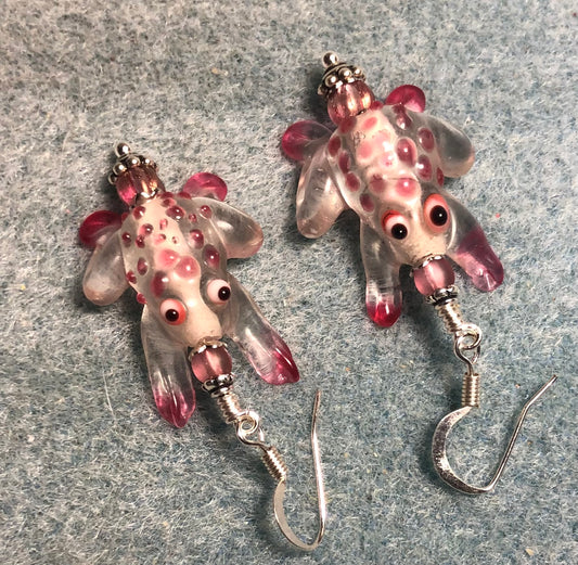 Clear and pink lamp work spotted frog bead earrings adorned with pink Czech glass beads.