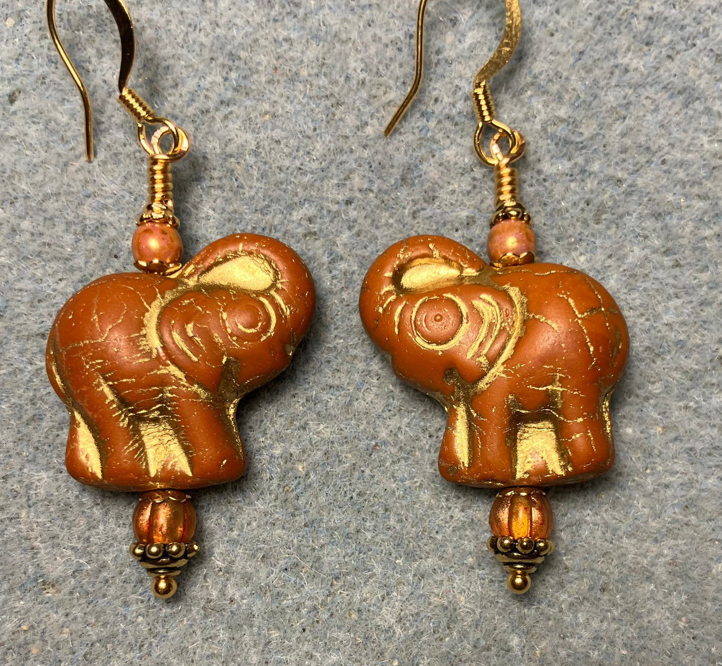 Light orange (with gold inlay) Czech glass elephant bead earrings adorned with light orange Czech glass beads.