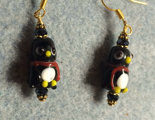 Black and white lamp work penguin bead earrings adorned with black Chinese crystal beads.