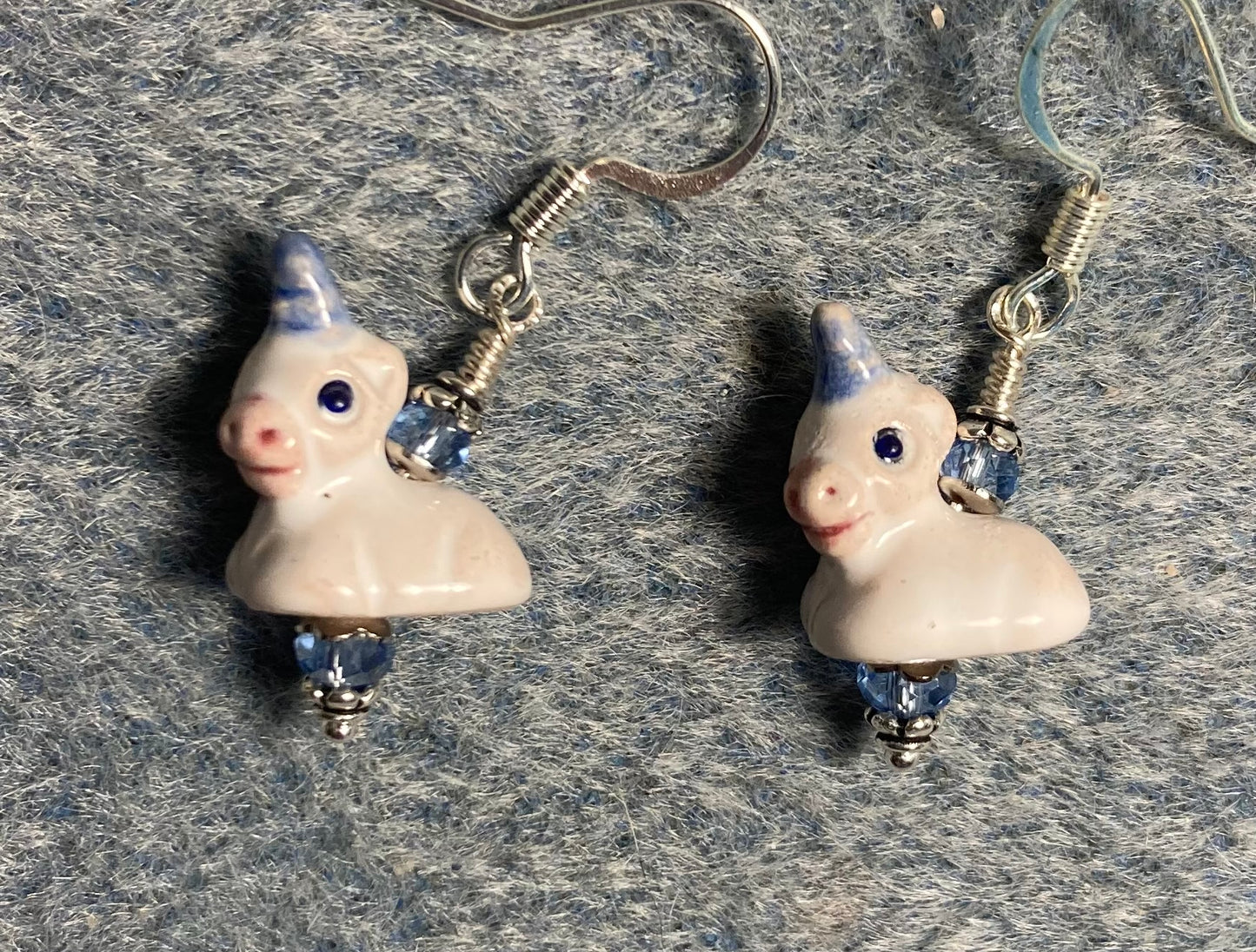 Small white and light blue ceramic unicorn bead earrings adorned with light blue Chinese crystal beads.