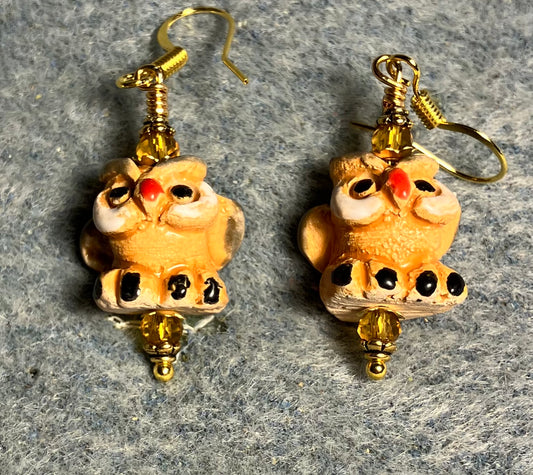Small amber, black, and red ceramic owl bead earrings adorned with amber Chinese crystal beads.