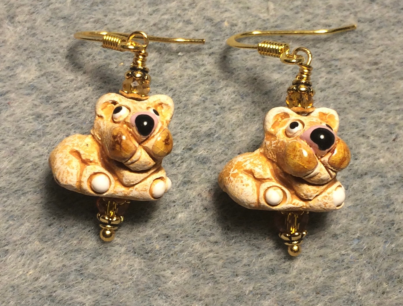 Small tan and brown ceramic lion bead earrings adorned with amber Chinese crystal beads.