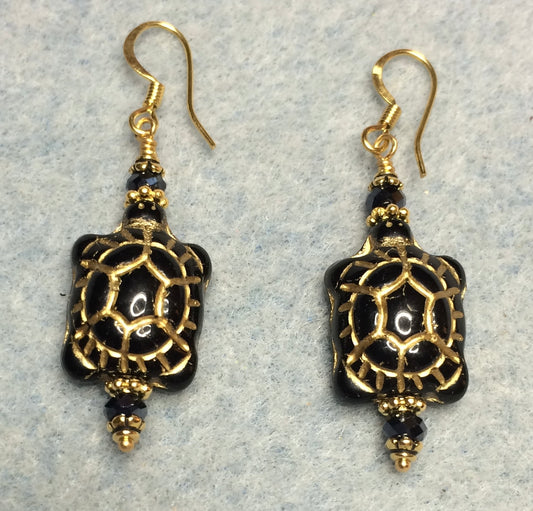 Black (with gold inlay) Czech glass turtle bead earrings adorned with black Chinese crystal beads.