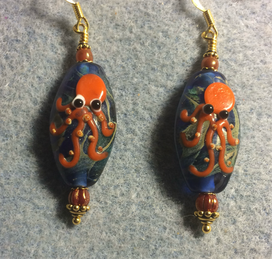 Blue and orange lamp work octopus bead earrings adorned with orange Czech glass beads.