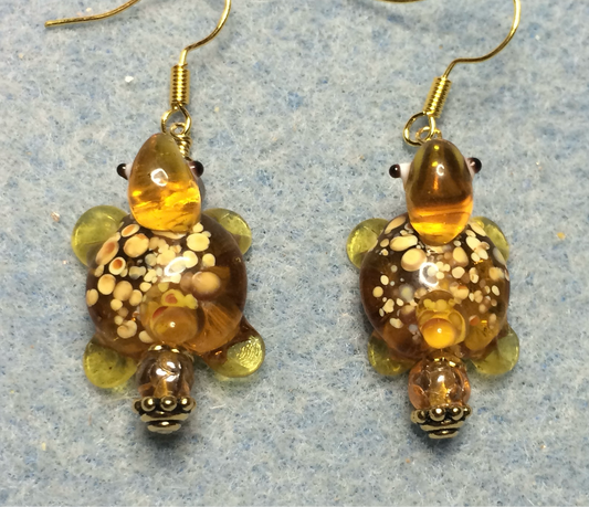 Translucent amber lamp work spotted turtle bead earrings adorned with amber Czech glass beads.