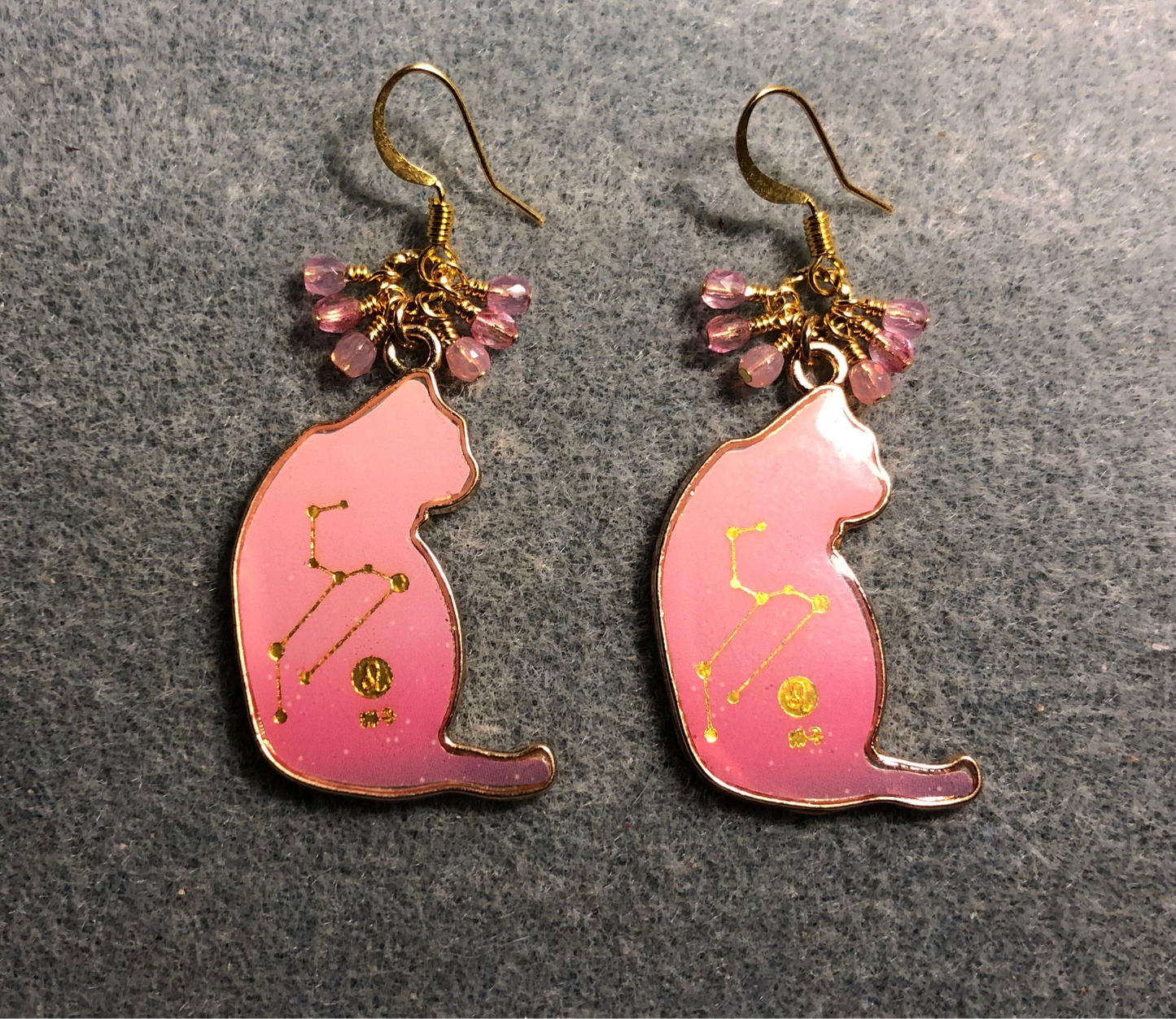 Pink and gold enamel cat charm earrings adorned with tiny dangling pink Czech glass beads.