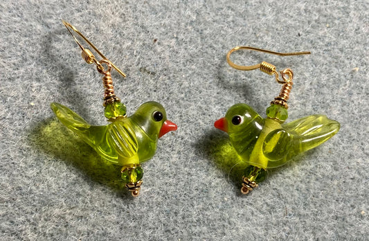Translucent olive green lamp work songbird bead earrings adorned with olive green Chinese crystal beads.