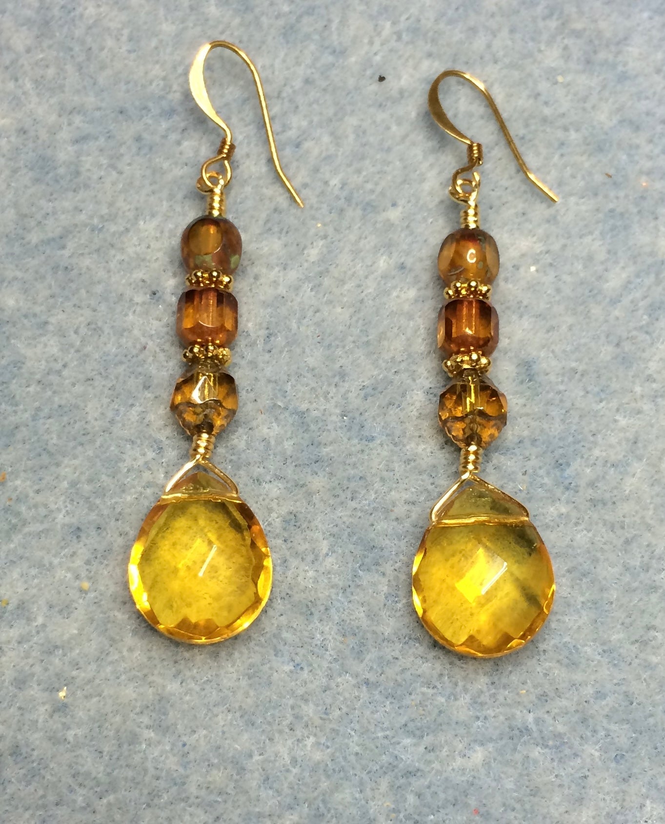 Topaz Czech glass briolette bead earrings adorned with topaz Czech glass beads.