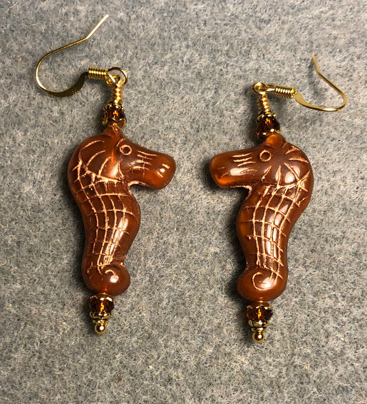 Caramel (with gold inlay) Czech glass seahorse bead earrings adorned with brown Chinese crystal beads.