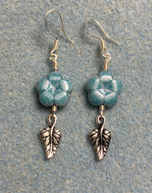 Light blue Czech glass puffy flower bead earrings adorned with silver Tierracast leaf charms.
