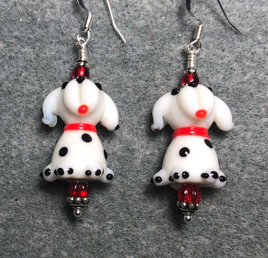 White, black, and red lamp work puppy dog bead earrings adorned with red Czech glass beads.