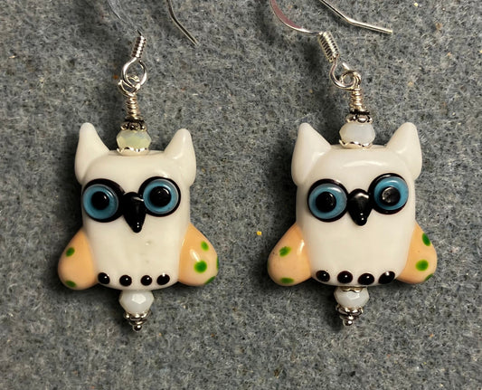 White and yellow lamp work owl bead earrings adorned with white Chinese crystal beads.