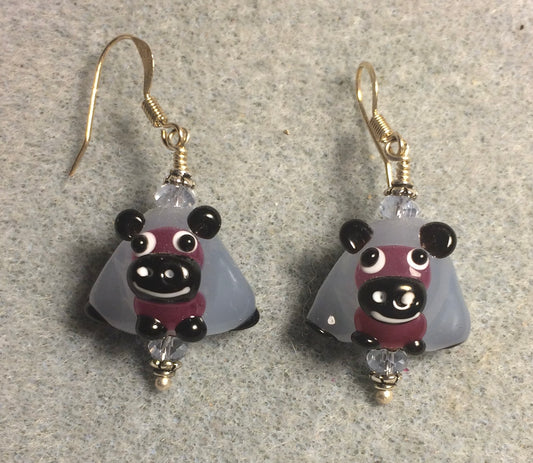 Light blue, purple, and black lamp work sheep bead earrings adorned with light blue Chinese crystal beads.