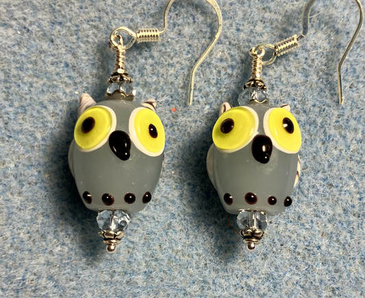 Light blue lamp work owl bead earrings adorned with light blue Chinese crystal beads.