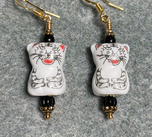 White, black, and red ceramic  cat bead earrings adorned with black Czech glass beads.