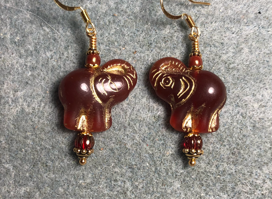 Burnt orange (with gold inlay) Czech glass elephant bead earrings adorned with burnt orange Czech glass beads.