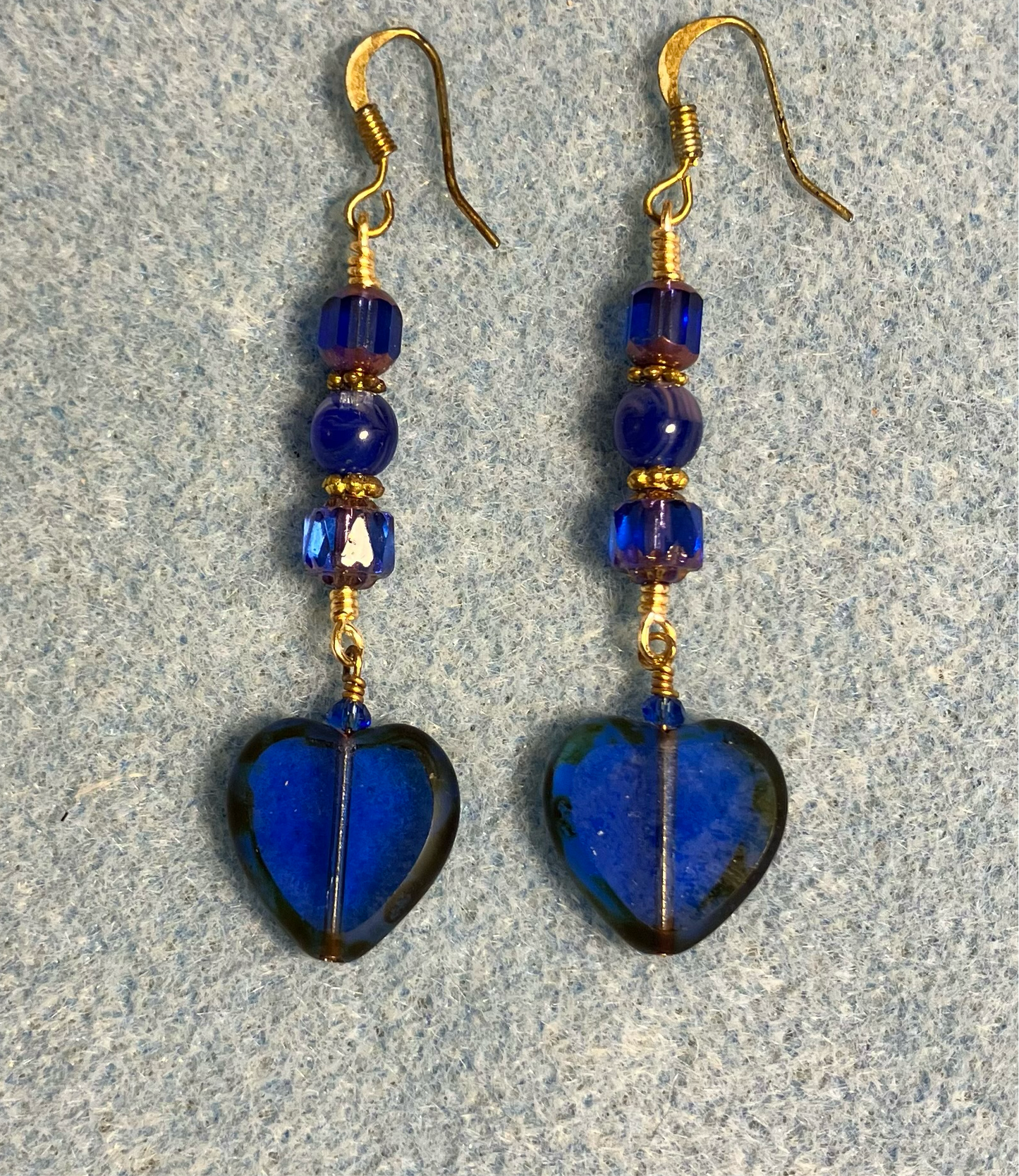 Translucent dark blue Czech glass heart bead earrings adorned with dark blue Czech glass beads.