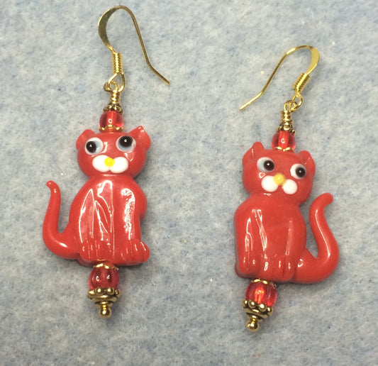 Opaque red lamp work cat bead earrings adorned with red Czech glass beads.