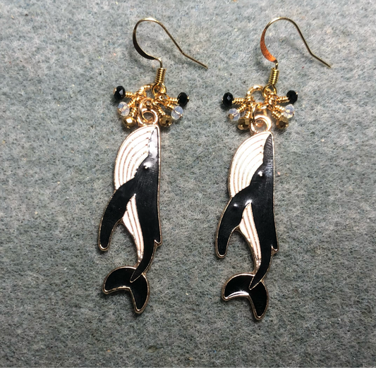 Long black and white enamel whale charm earrings adorned with tiny dangling black, white,and gold Chinese crystal beads.
