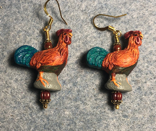 Orange, green, and red ceramic rooster bead earrings adorned with orange Czech glass beads.