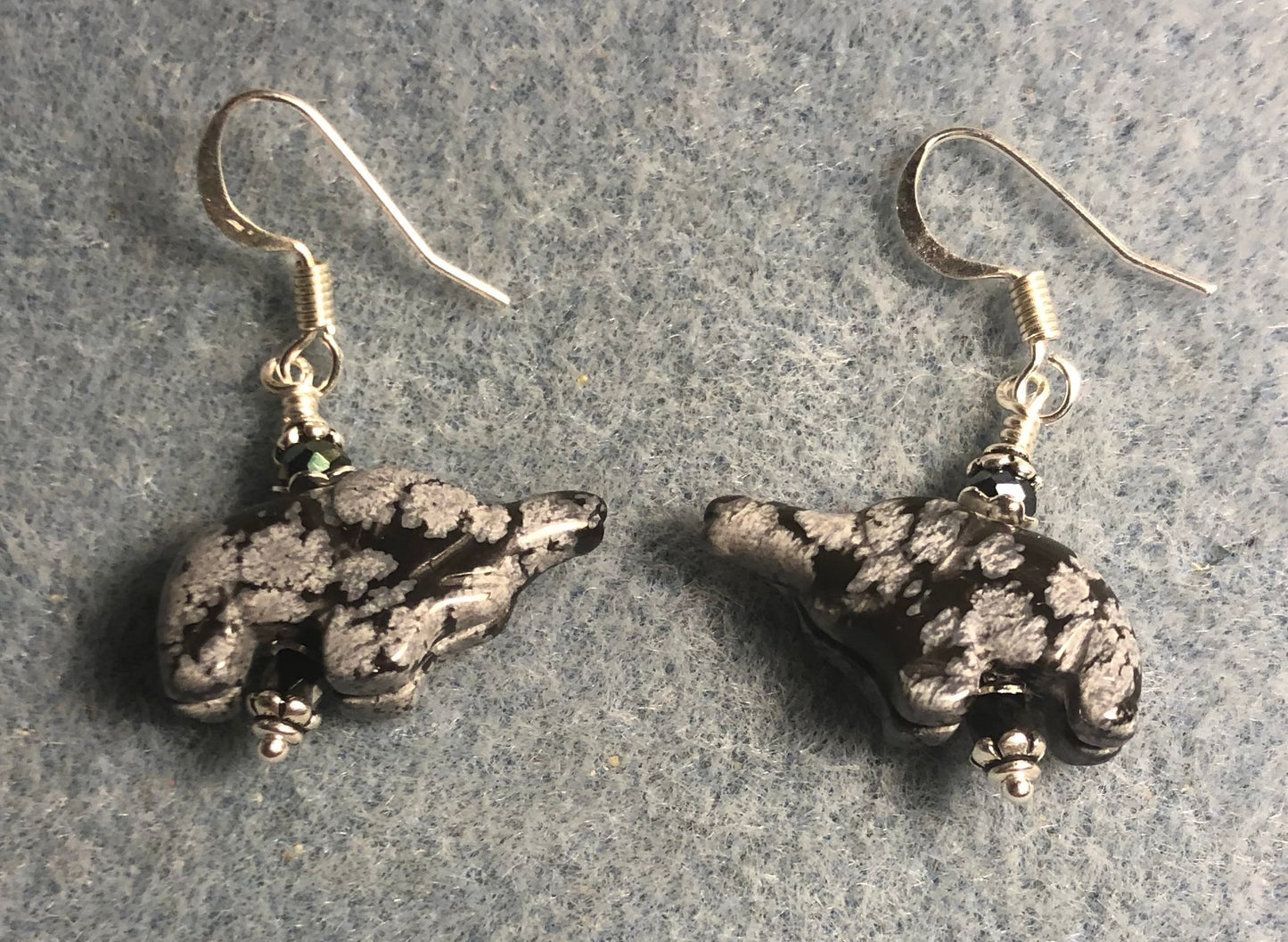 Small snowflake obsidian gemstone elephant bead earrings adorned with black Chinese crystal beads.