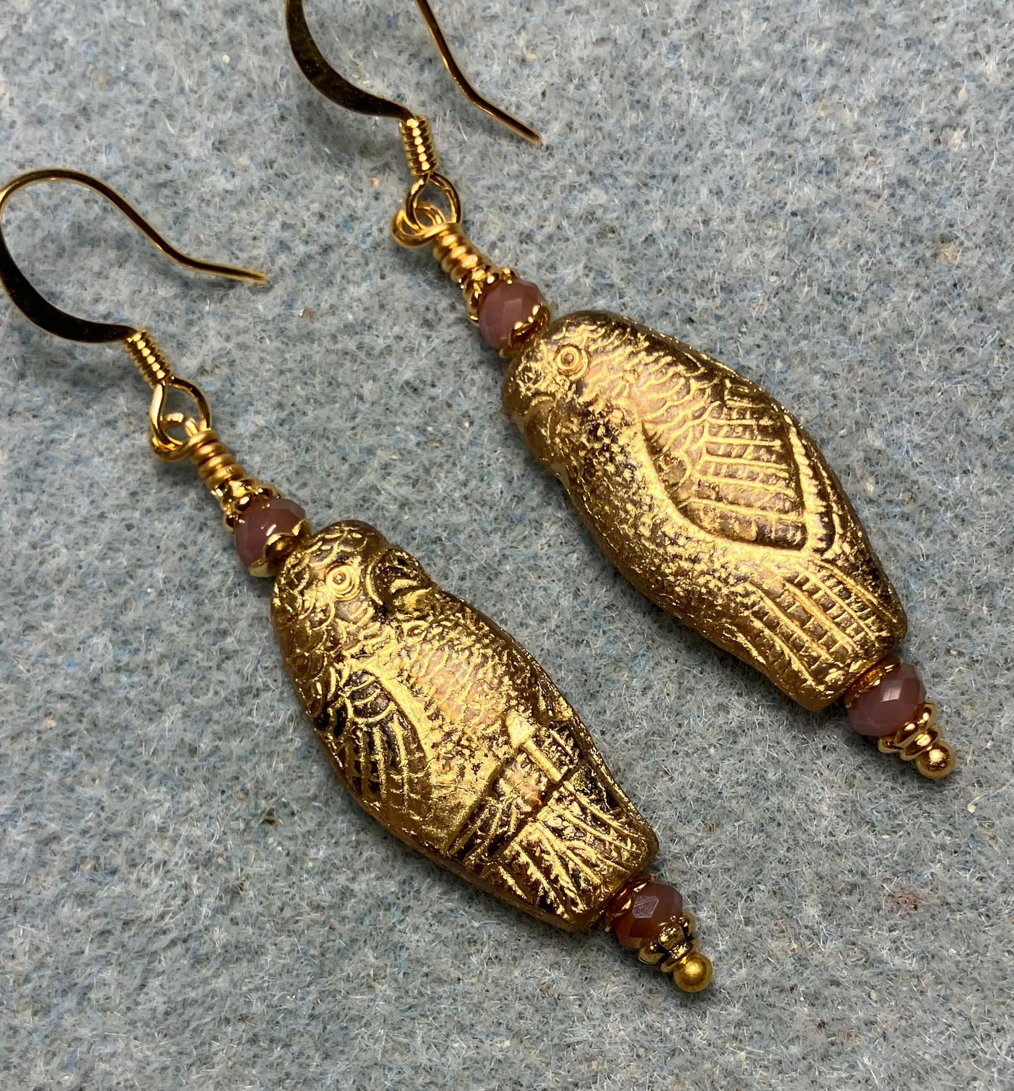 Large violet (with gold wash) Czech glass parrot bead earrings adorned with violet Chinese crystal beads.