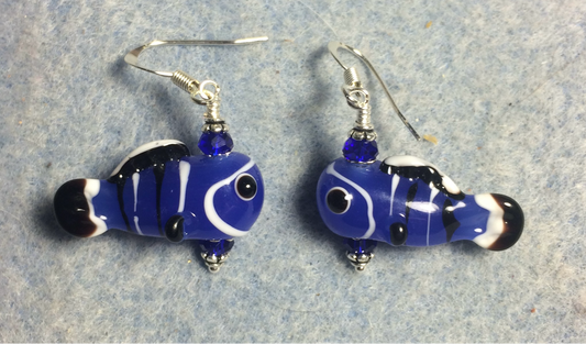 Dark blue, black, and white lamp work fish bead earrings adorned with dark blue Chinese crystal beads.