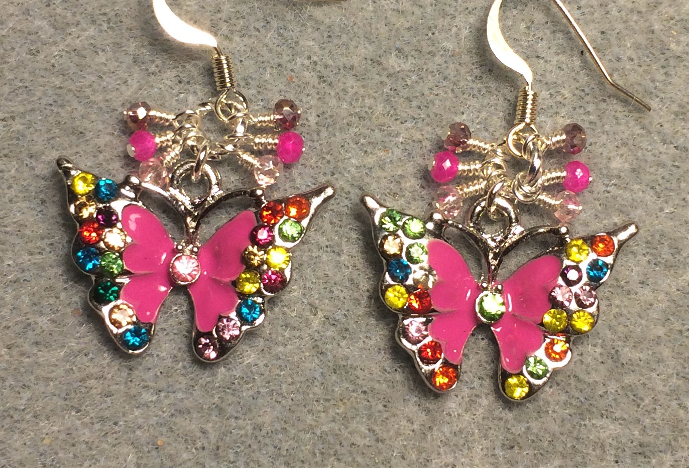 Hot pink enamel and colored rhinestone butterfly charm earrings adorned with tiny dangling hot pink and light pink Chinese crystal beads.