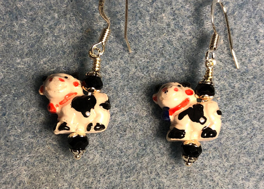 Small black, white and red ceramic cow bead earrings adorned with black Chinese crystal beads.