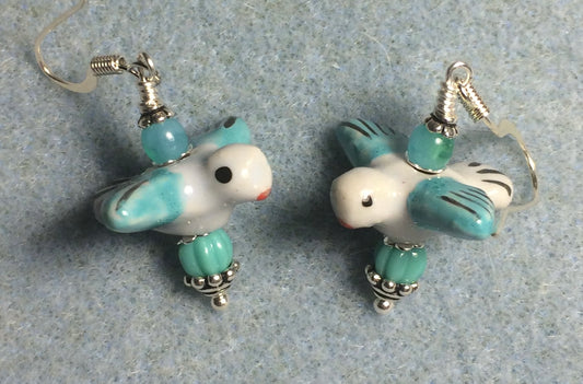 Turquoise and white ceramic flying bird bead earrings adorned with turquoise Czech glass beads.