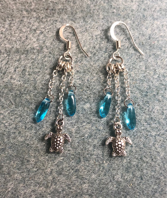 Small silver sea turtle charm earrings attached to silver chain and adorned with small turquoise Czech glass dagger beads.