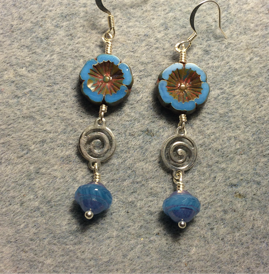 Opaque blue Czech glass pansy bead earrings adorned with silver swirly connectors and blue Czech glass Saturn beads.